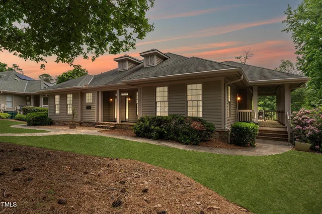 a front view of a house with yard and green space