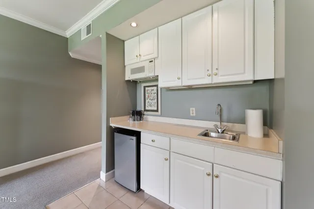 a kitchen with stainless steel appliances granite countertop a refrigerator and a stove