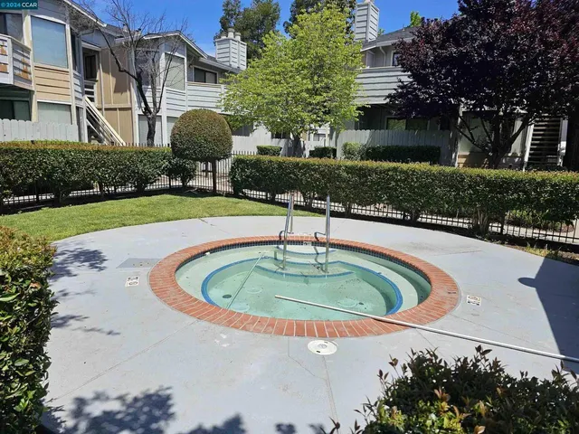 a swimming pool with outdoor seating and garden