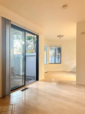 a view of an empty room with glass door