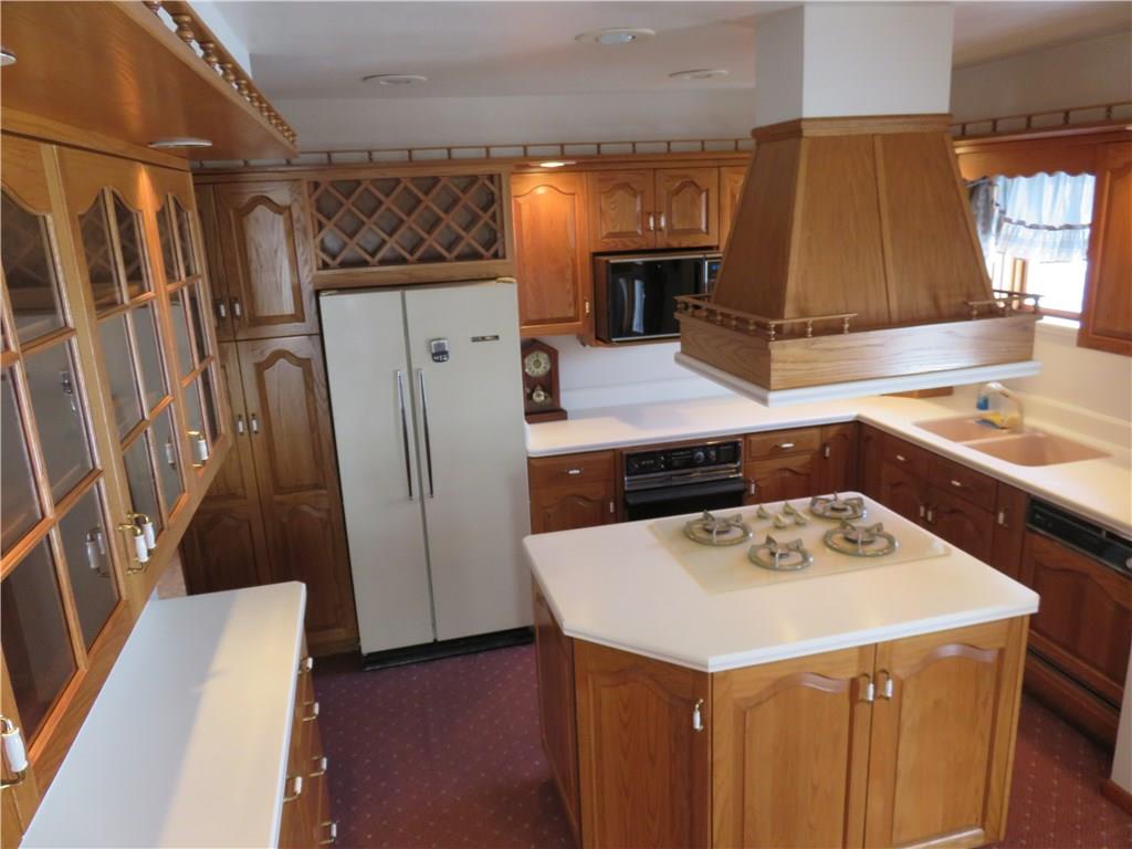 1860 Mercer Grove City Road Mercer, PA 16137 - Photo 23 of 25 Oak cabinets, Island with gas top range, Corian counters, recessed lighting, & appliances.