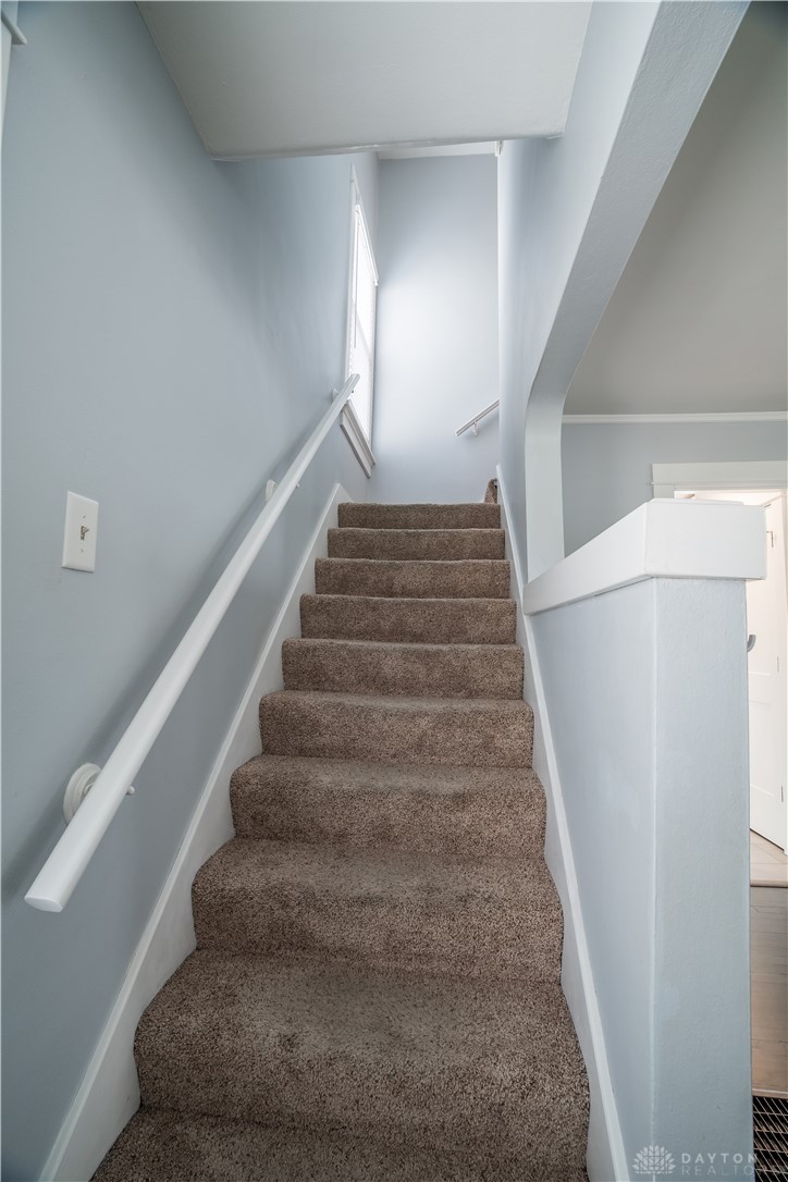 303 South Ridge Avenue Troy, OH 45373 - Photo 14 of 37 This interior staircase features soft carpeting, guiding you between levels of the home.