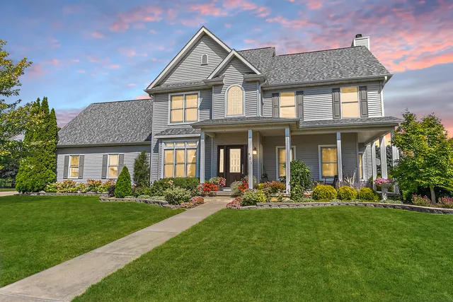 a front view of a house with swing and garden
