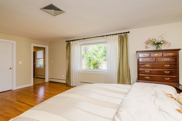 23 Solomon Pierce Road Lexington, MA 02420 - Photo 12 of 26 a bedroom with a bed and a dresser