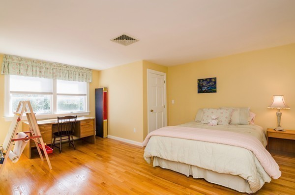 23 Solomon Pierce Road Lexington, MA 02420 - Photo 15 of 26 a bedroom with a bed and large windows