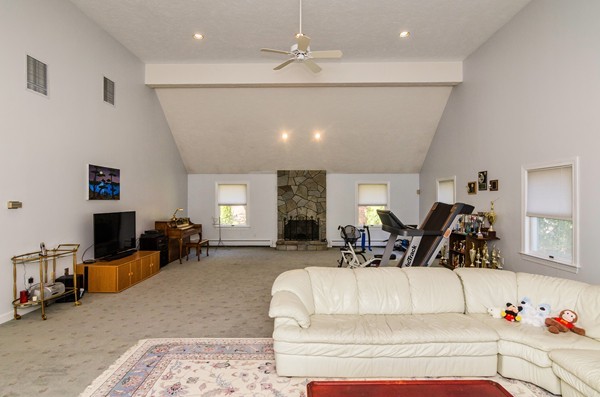 23 Solomon Pierce Road Lexington, MA 02420 - Photo 17 of 26 a living room with furniture gym equipment and a chandelier