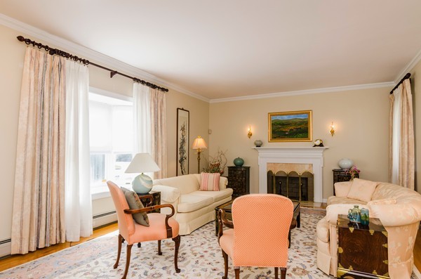 23 Solomon Pierce Road Lexington, MA 02420 - Photo 4 of 26 a living room with furniture a fireplace and a flat screen tv