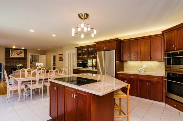 23 Solomon Pierce Road Lexington, MA 02420 - Photo 7 of 26 a kitchen with stainless steel appliances granite countertop a sink a stove and a refrigerator