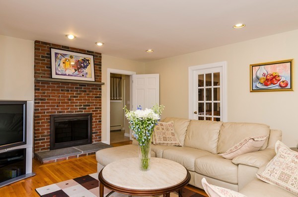 23 Solomon Pierce Road Lexington, MA 02420 - Photo 9 of 26 a living room with furniture potted plant and a fireplace