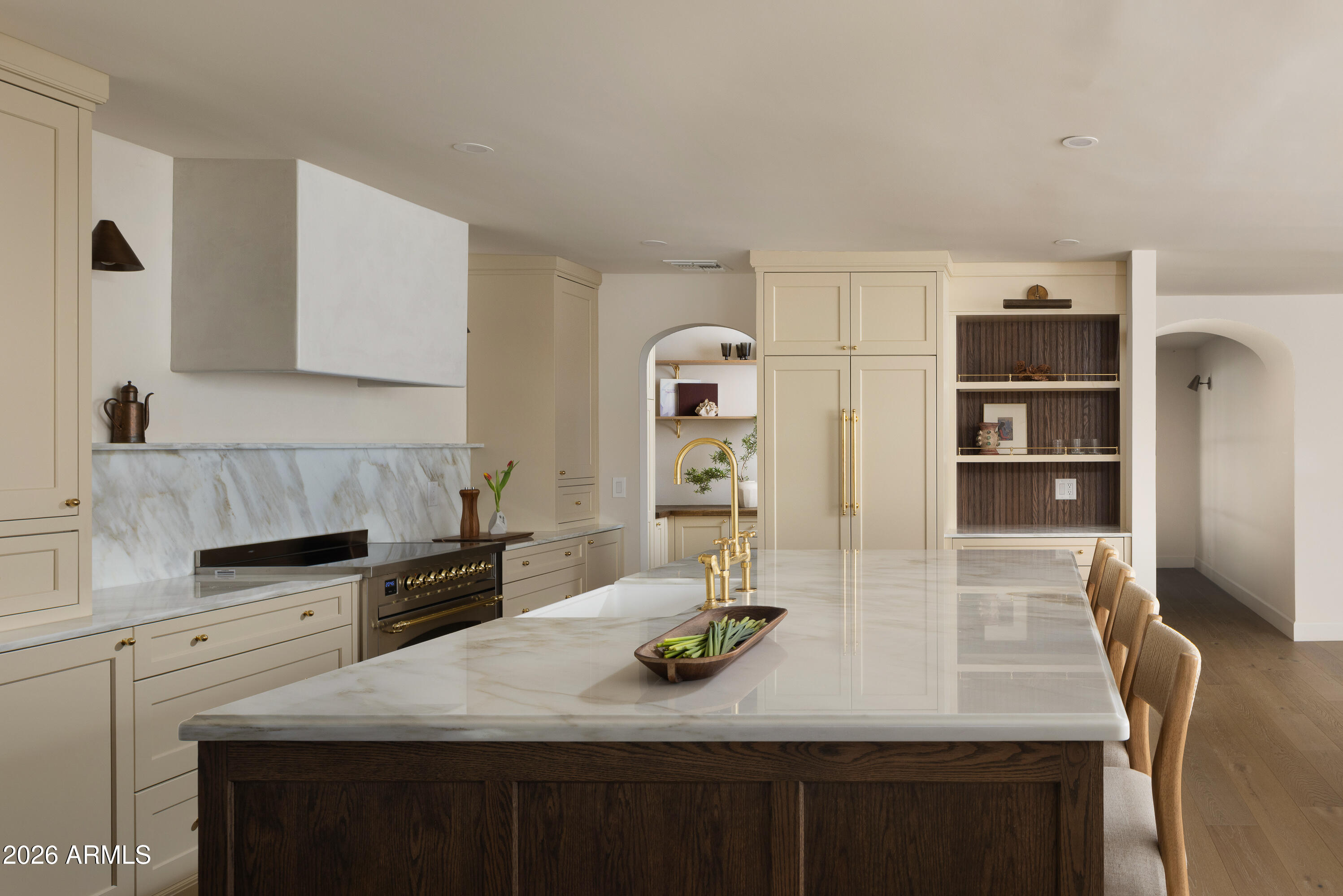 5501 East Camelback Road Phoenix, AZ 85018 - Photo 16 of 60 a kitchen with stainless steel appliances kitchen island granite countertop a table chairs and a refrigerator