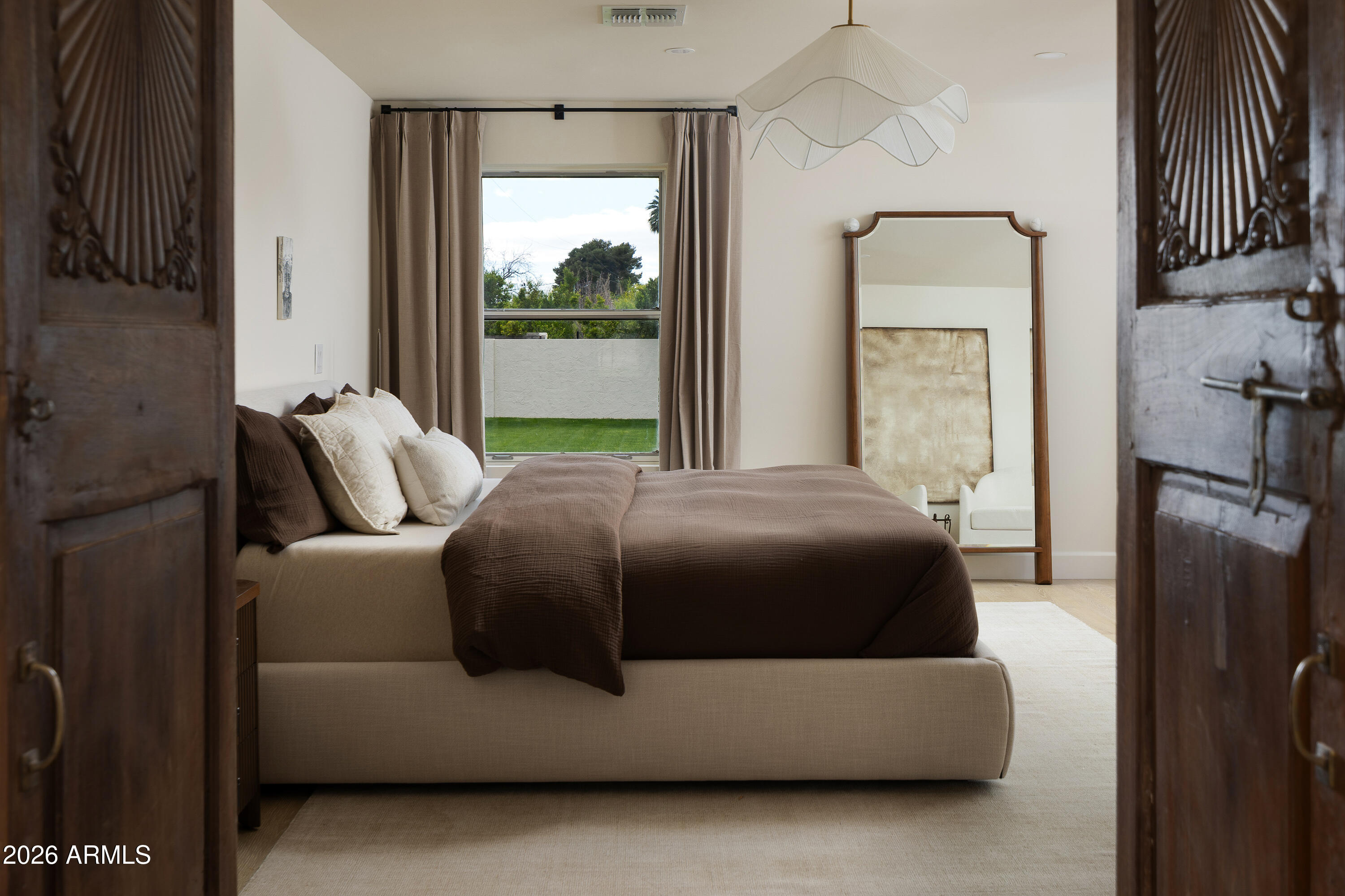 5501 East Camelback Road Phoenix, AZ 85018 - Photo 32 of 60 a room with a bed and a mirror