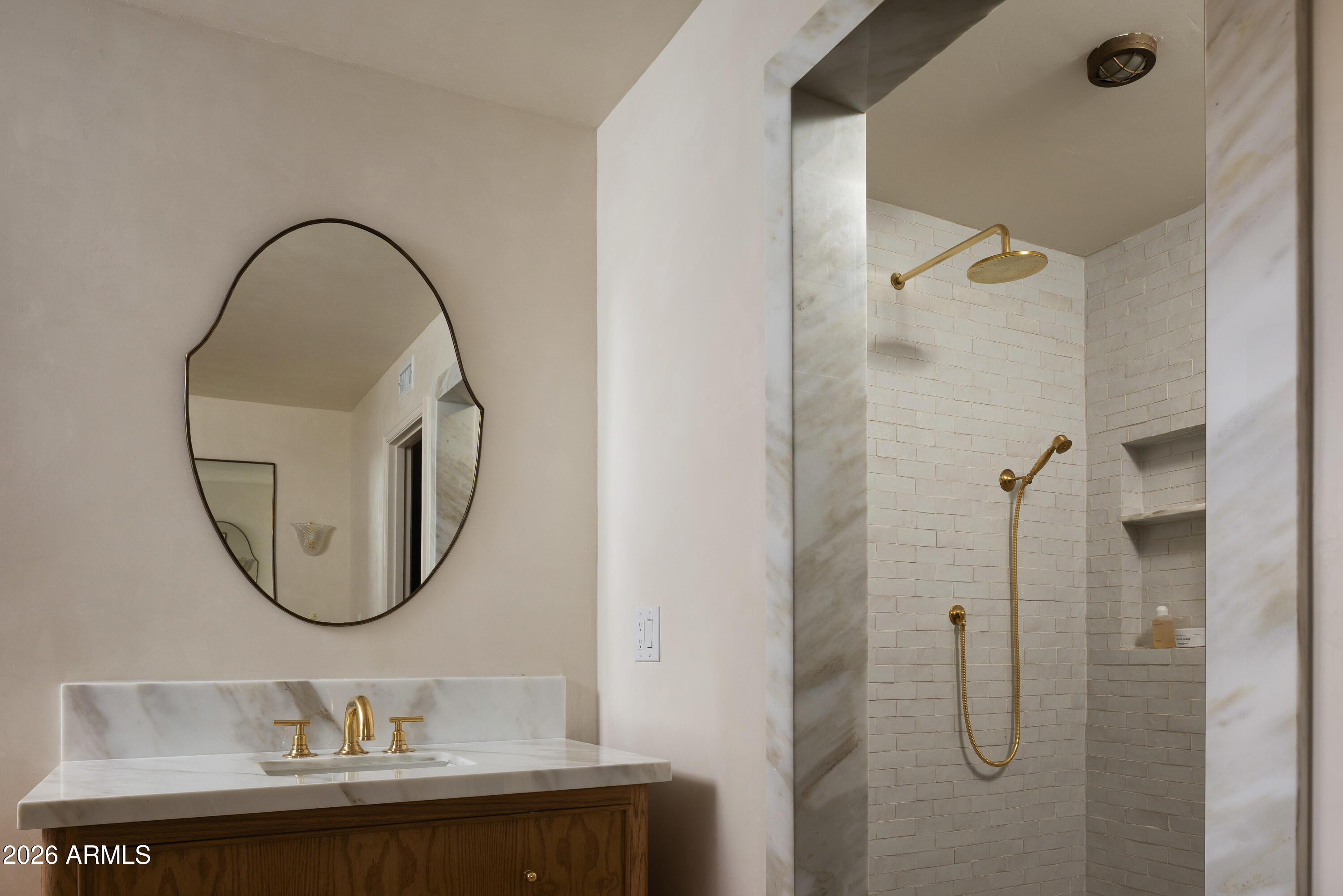 5501 East Camelback Road Phoenix, AZ 85018 - Photo 38 of 60 a bathroom with a sink a mirror a glass door a shower and a mirror