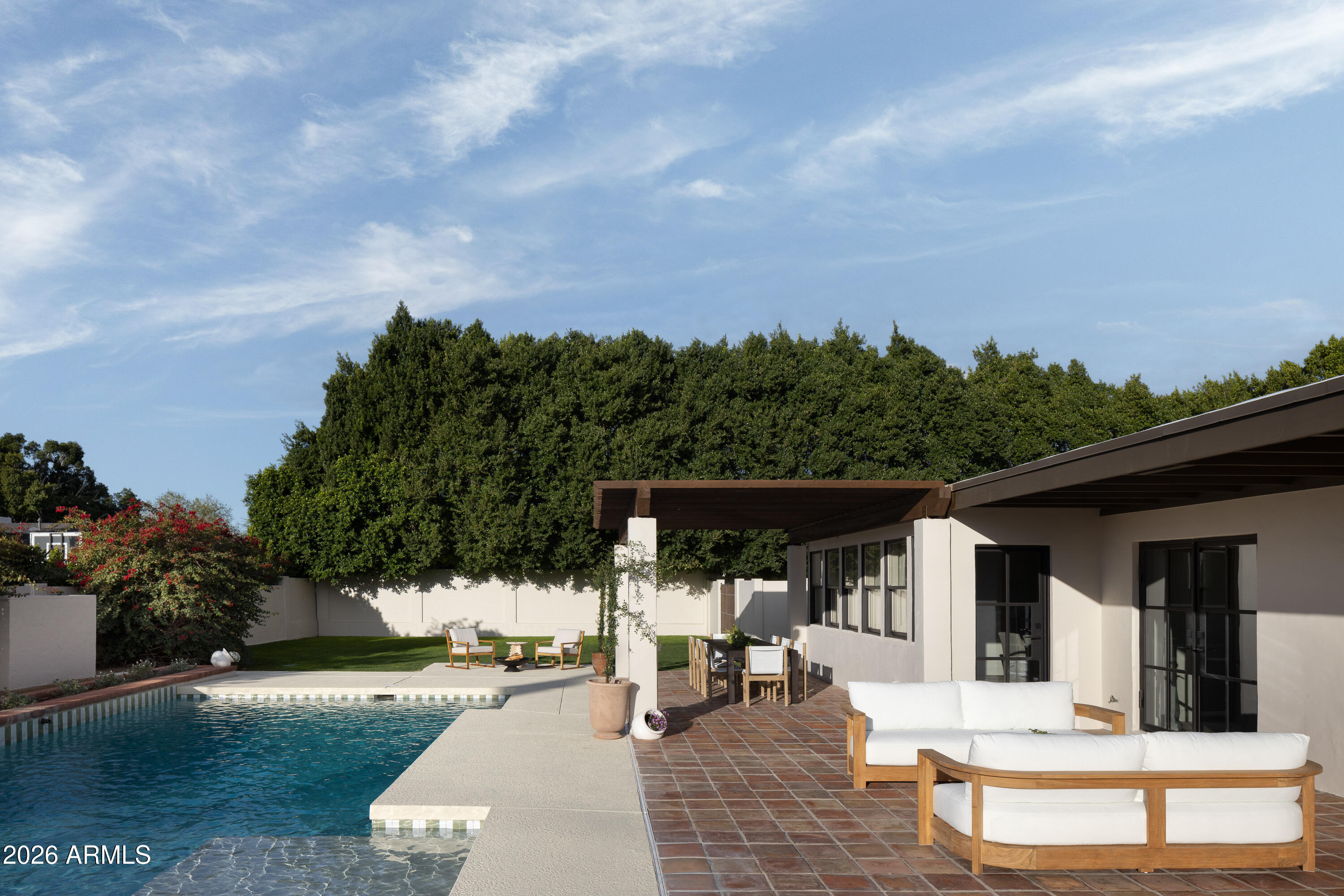 5501 East Camelback Road Phoenix, AZ 85018 - Photo 46 of 60 a view of a patio with couches table and chairs and potted plants