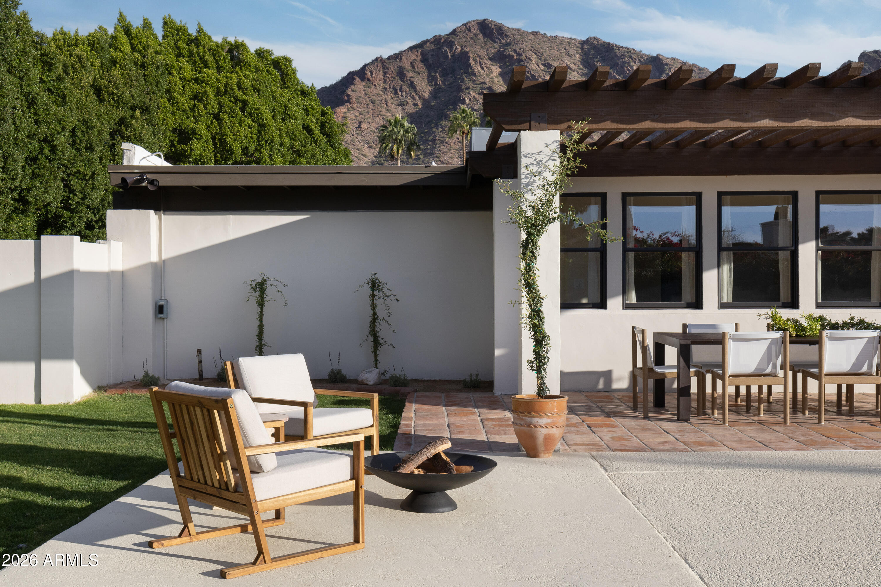 5501 East Camelback Road Phoenix, AZ 85018 - Photo 51 of 60 a patio with a table and chairs