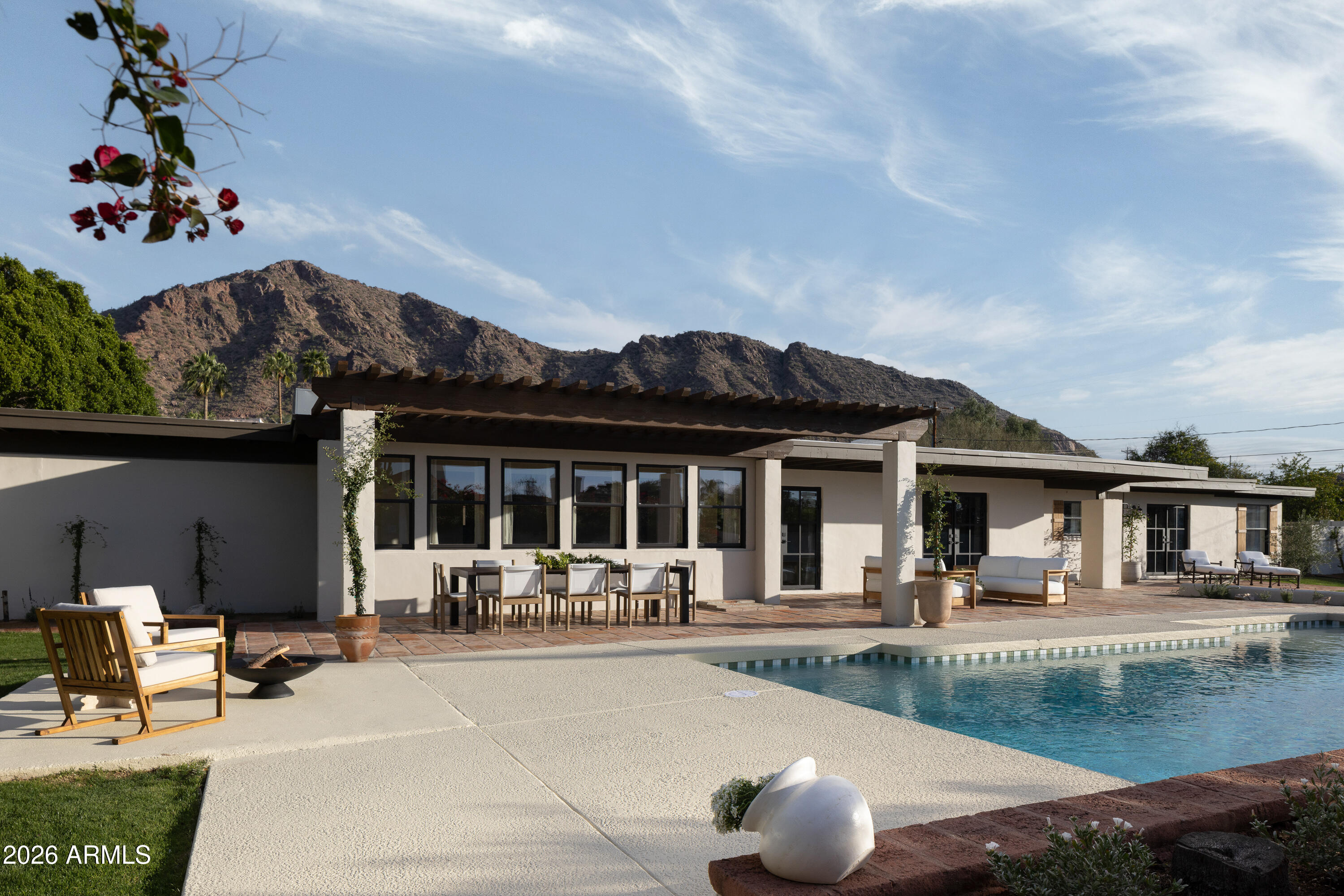 5501 East Camelback Road Phoenix, AZ 85018 - Photo 52 of 60 a view of a patio with couches table and chairs and potted plants