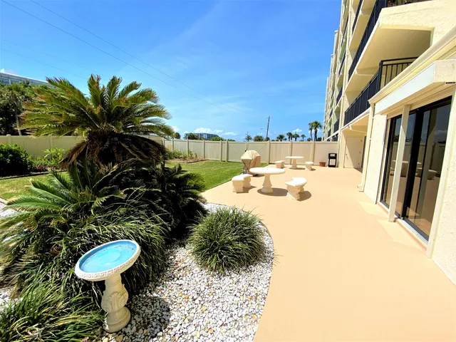 a view of a swimming pool with chair and tables
