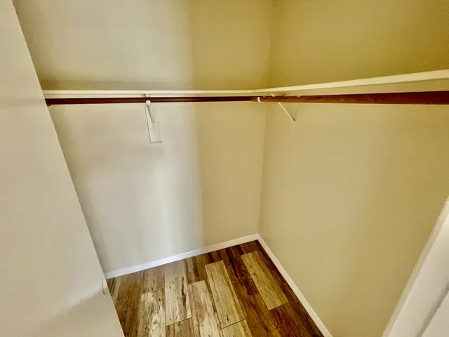 a view of a room with wooden floor