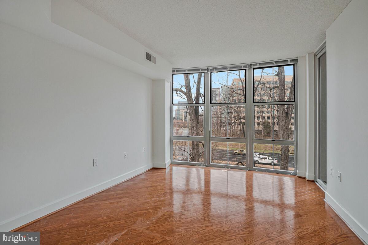 11800 Sunset Hills Road, Unit 514 Reston, VA 20190 - Photo 51 of 57 a view of an empty room with wooden floor and a window