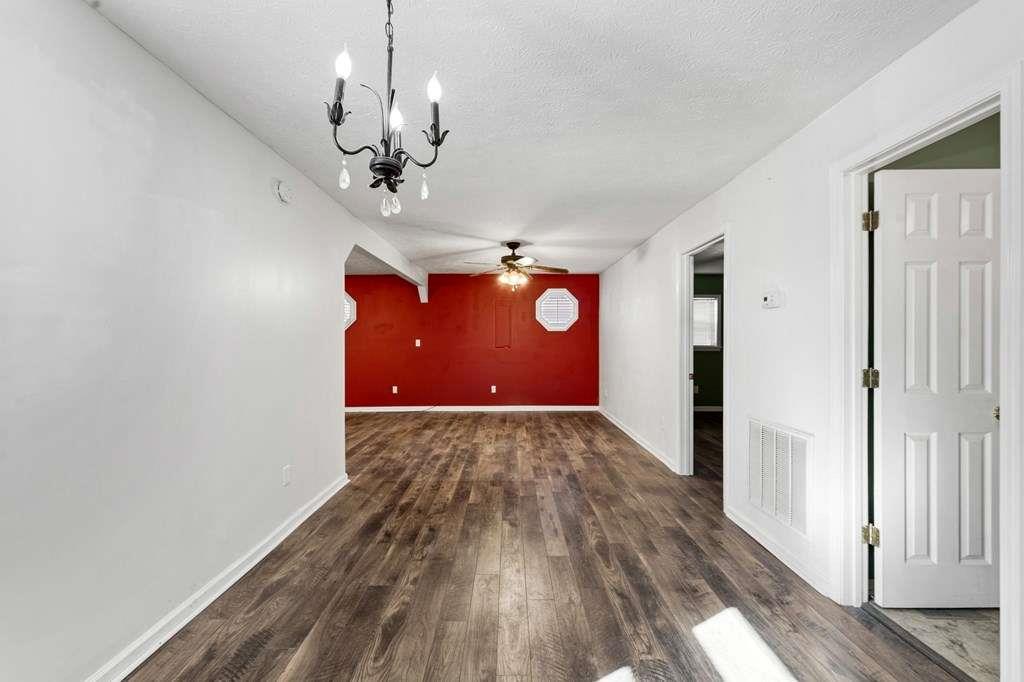 118 Jordan Road Blairsville, GA 30512 - Photo 11 of 49 a view of a livingroom with a chandelier fan and wooden floor