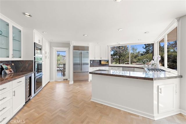 a kitchen with stainless steel appliances granite countertop a sink and cabinets