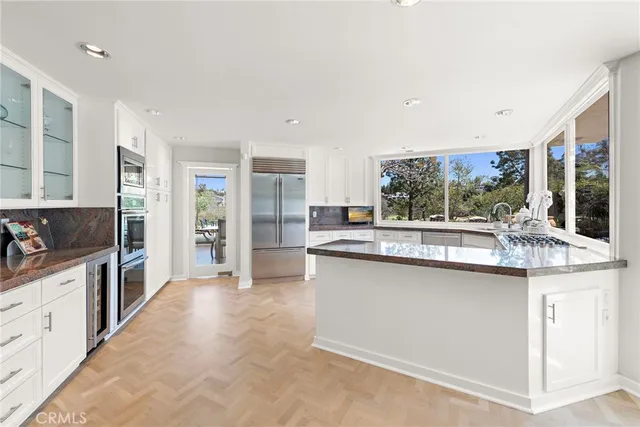 a kitchen with stainless steel appliances granite countertop a sink and cabinets