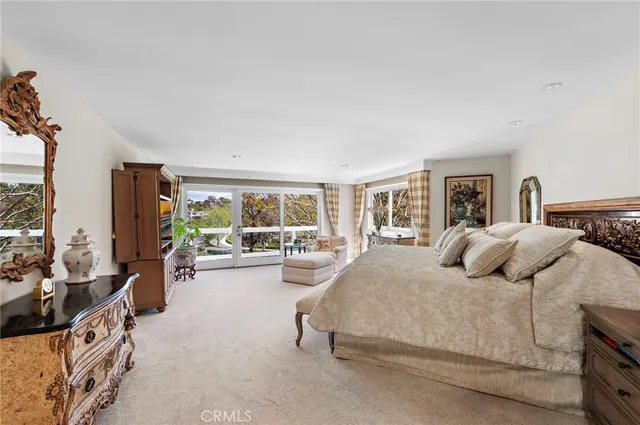 a bedroom with a large bed and a large window