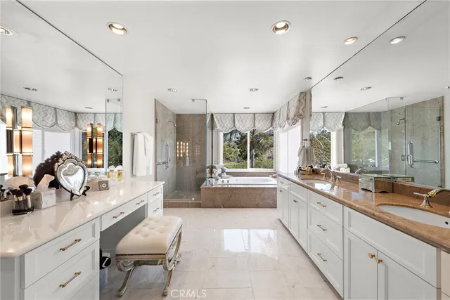 a large white kitchen with a large window and stainless steel appliances