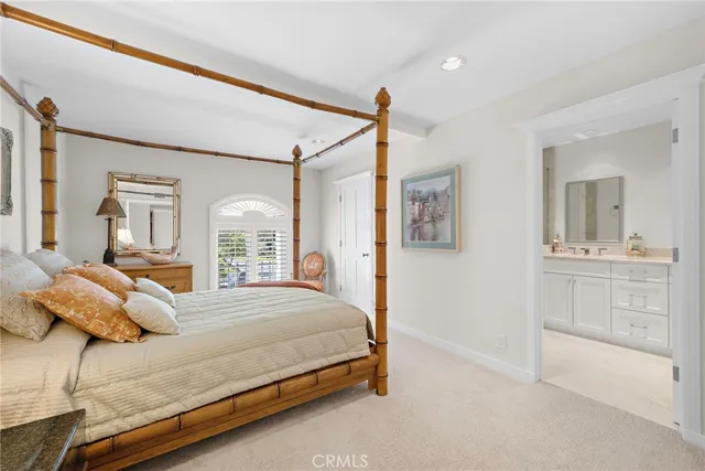 a bedroom with a bed and a mirror