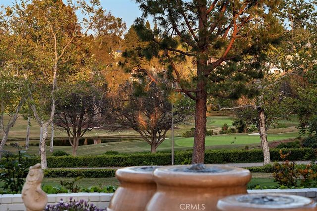a view of a street with large trees