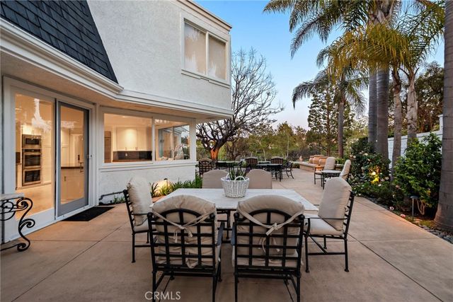 a view of a patio with table and chairs and potted plants