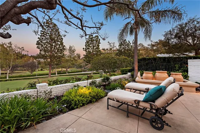 a balcony with outdoor seating and city view