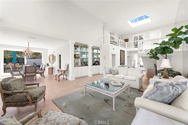 a living room with furniture potted plant and a large window