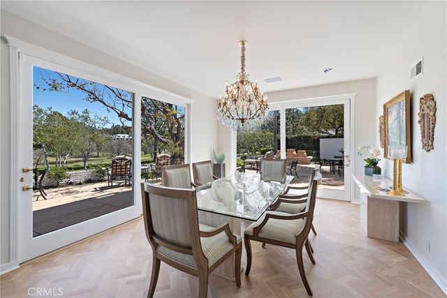 a dining room with furniture a chandelier and window
