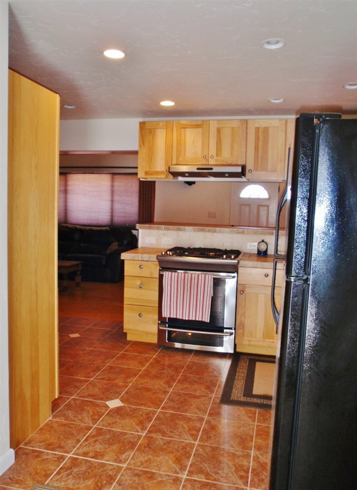 1608 12 Road Loma, CO 81524 - Photo 5 of 22 a kitchen with a stove window and cabinets