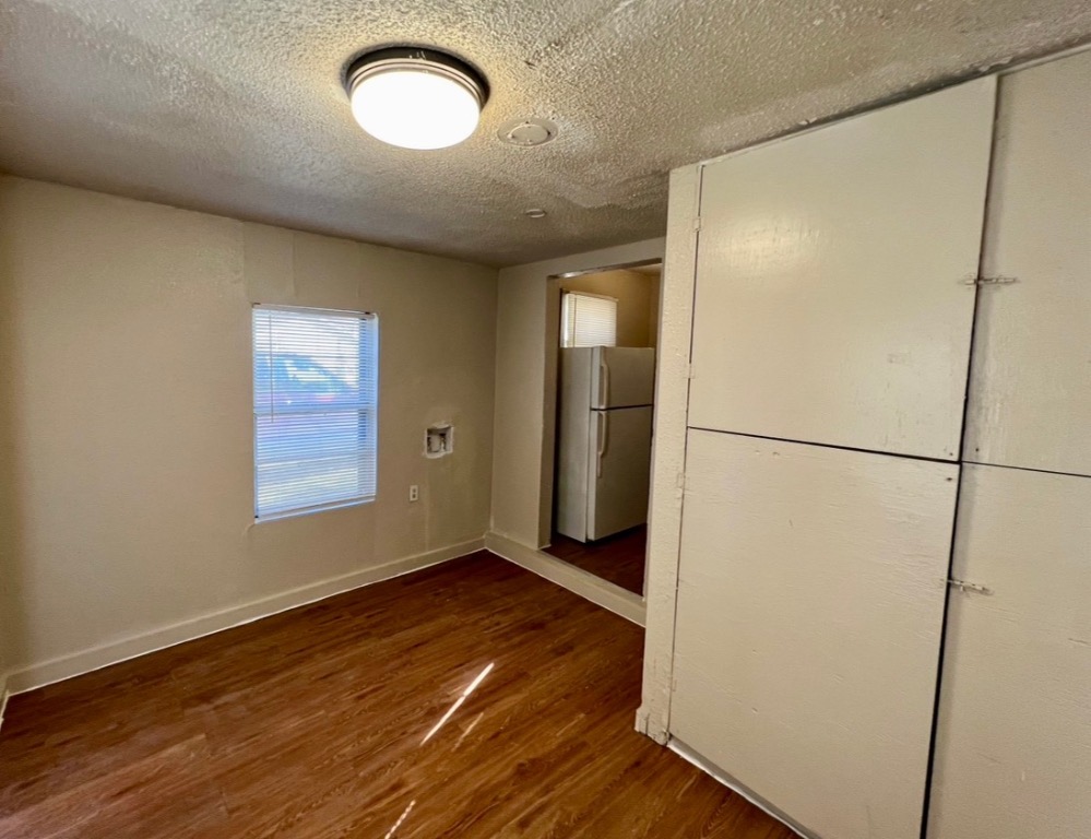 514 Ruddy Street, Unit A Lockhart, TX 78644 - Photo 6 of 9 a view of a room with wooden floor and a window