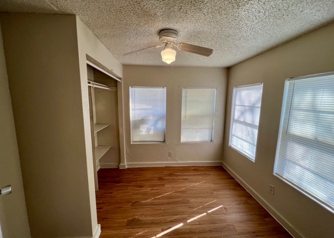 514 Ruddy Street, Unit A Lockhart, TX 78644 - Photo 7 of 9 a view of empty room with window and wooden floor