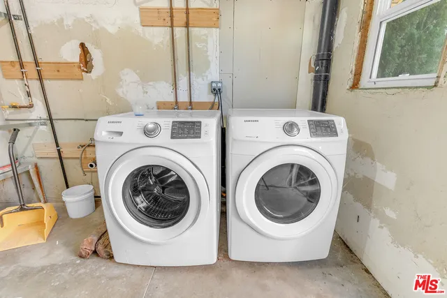 a bathroom with a granite countertop a sink and a shower