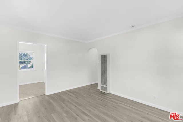 an empty room with wooden floor