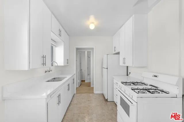 a kitchen with a sink stove and cabinets