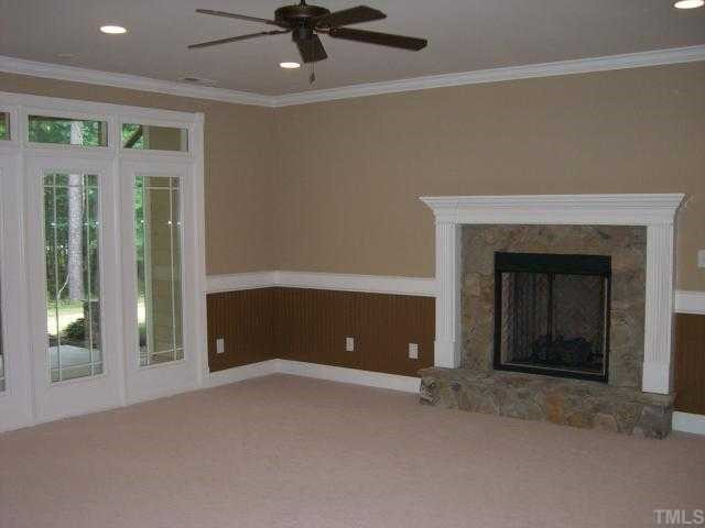 7204 Sparhawk Road Wake Forest, NC 27587 - Photo 11 of 12 Lower level family room features a beautiful stone fireplace.