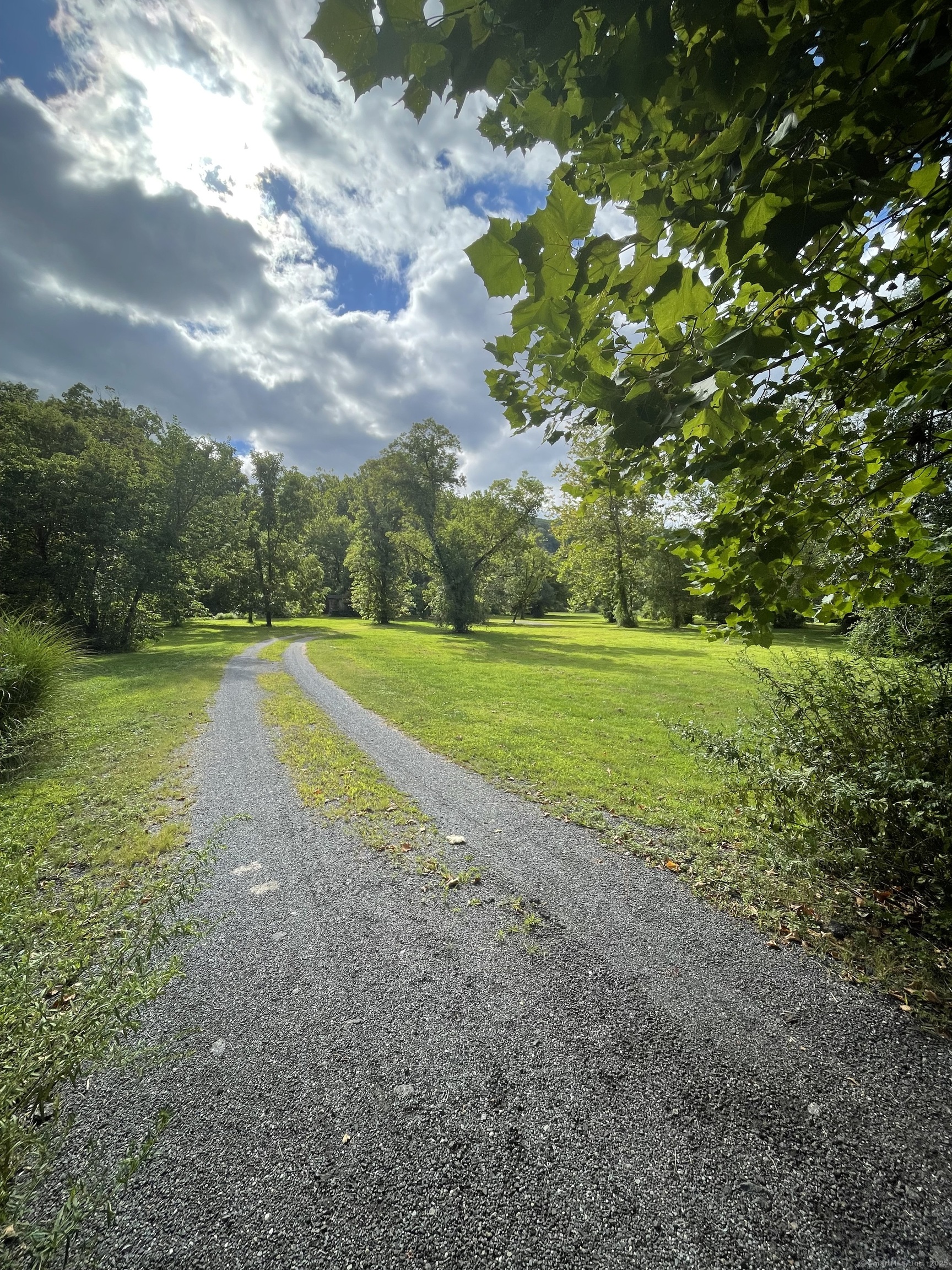 a view of a green field with wooden fence