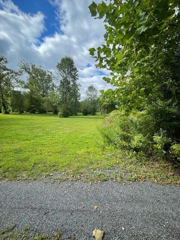 a view of a field with an trees