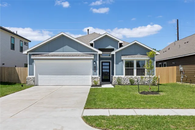 a front view of a house with a yard and outdoor seating