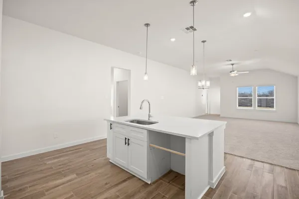 a view of a kitchen counter space a sink and a window