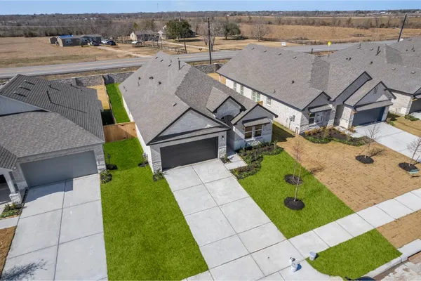 an aerial view of a house with a yard