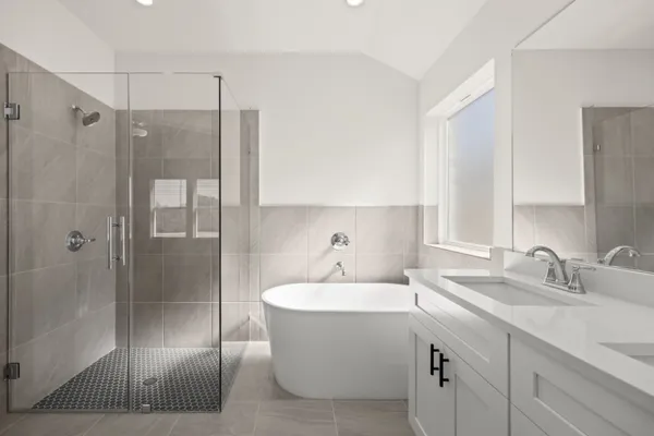 a bathroom with a double vanity sink mirror and shower