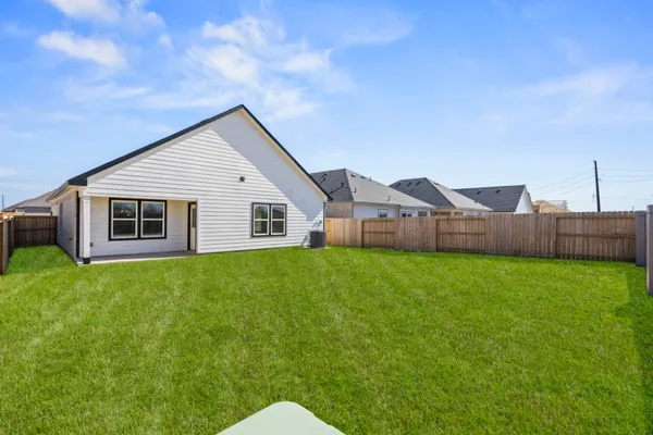 a view of a house with backyard and garden