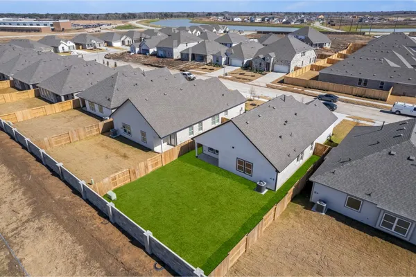 an aerial view of a house with a backyard