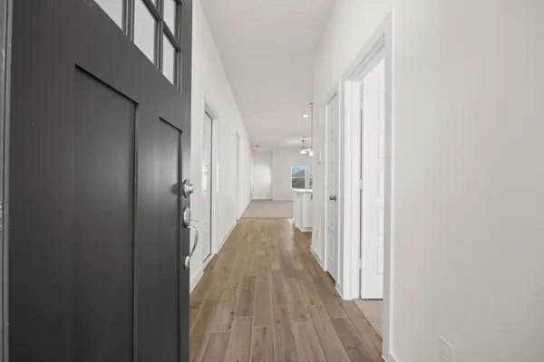 a view of a hallway with wooden floor