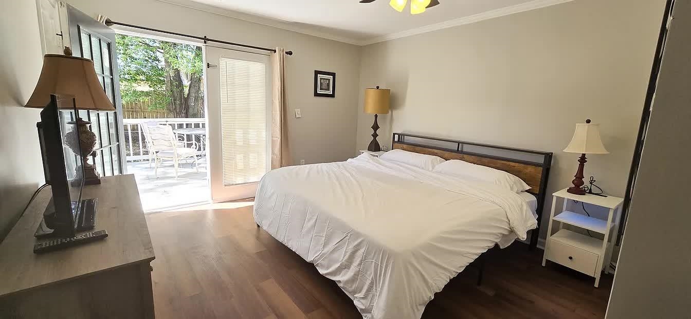 15 South Cox Street Memphis, TN 38104 - Photo 12 of 20 a bedroom with a bed and a flat tv screen on the dresser
